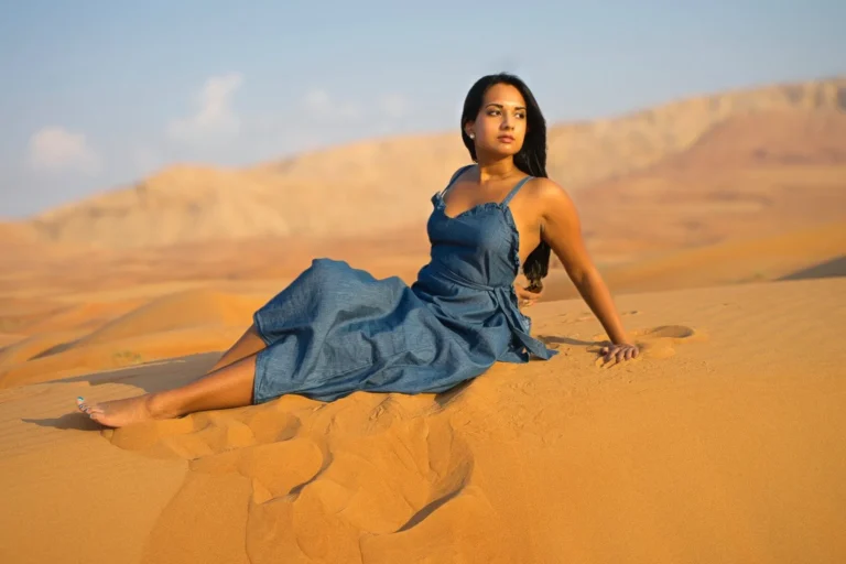Girlwithbluedressposingonsandindesertsafari